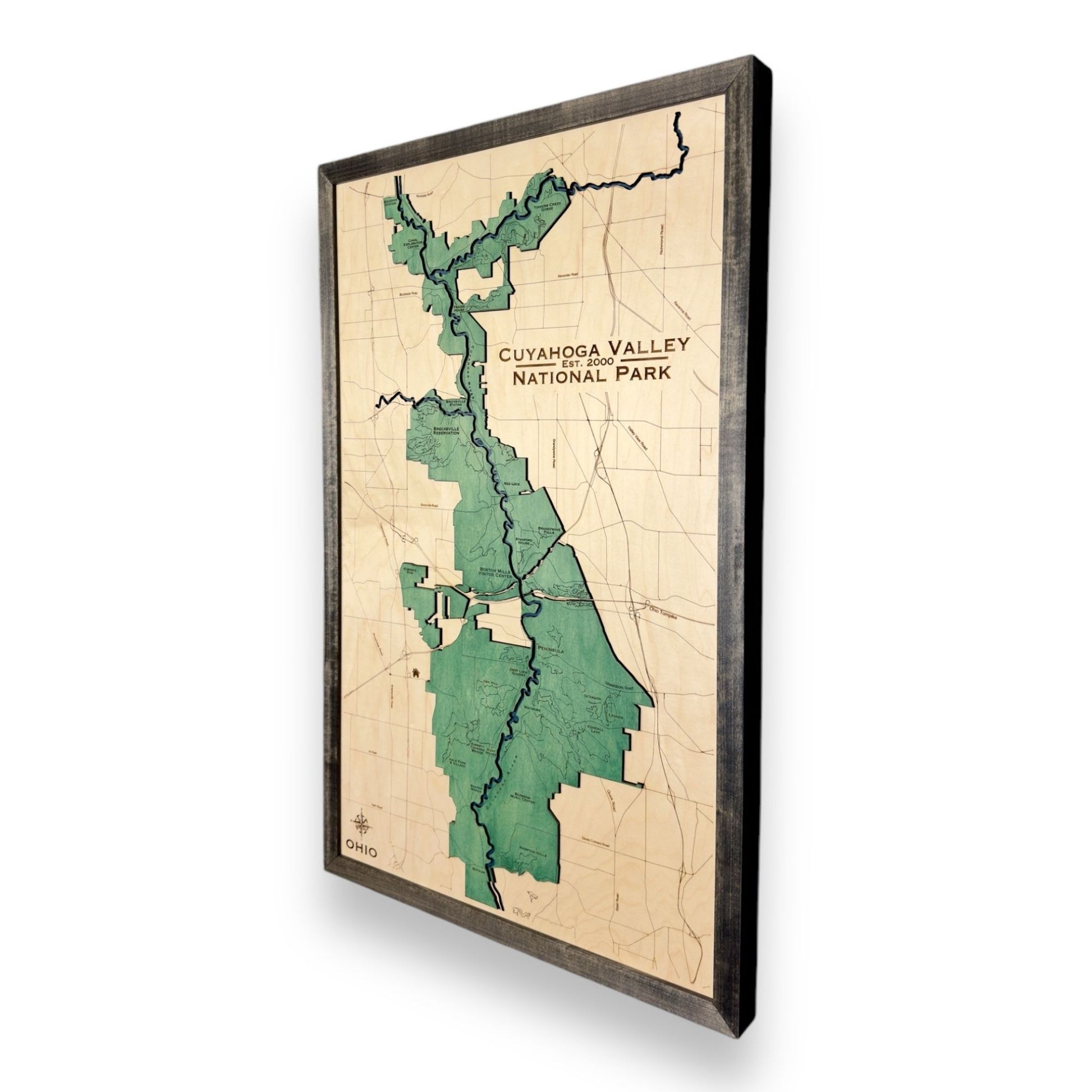 Sideview of a wooden map of Cuyahoga Valley National Park on a white background.