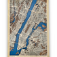 A 3D wooden map with raised streets and a blue river cut into the map. The map is of Manhattan. 