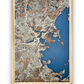 A wooden map of Boston, MA with 3D roads raised off of the base layer. The water layer is cut into he base layer and stained blue. 
