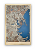 A wooden map of Boston, MA with 3D roads raised off of the base layer. The water layer is cut into he base layer and stained blue. 