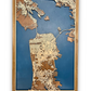 Wooden map of San Francisco with 3D roads. Blue water layer is cut into the map. 