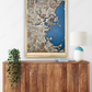 Large Boston city map hanging on the wall above a dresser. 