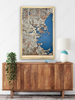 Large Boston city map hanging on the wall above a dresser. 