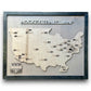 Wood hockey area travel map with grey stained background and black puck icons. There's a nameplate that can be personalized. 