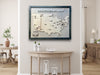 A large wooden hockey arena travel map with removable hockey puck icons. It's hanging on a wall above a table. 