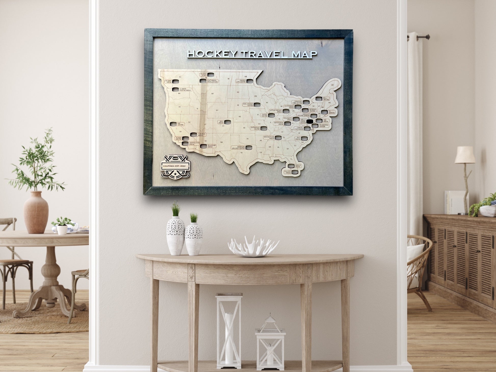 A large wooden hockey arena travel map with removable hockey puck icons. It's hanging on a wall above a table. 